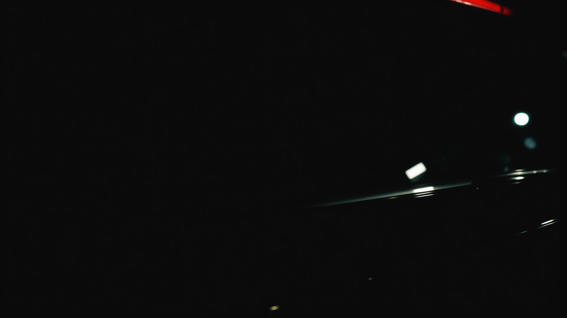 Dark vehicle with premium window tint at night